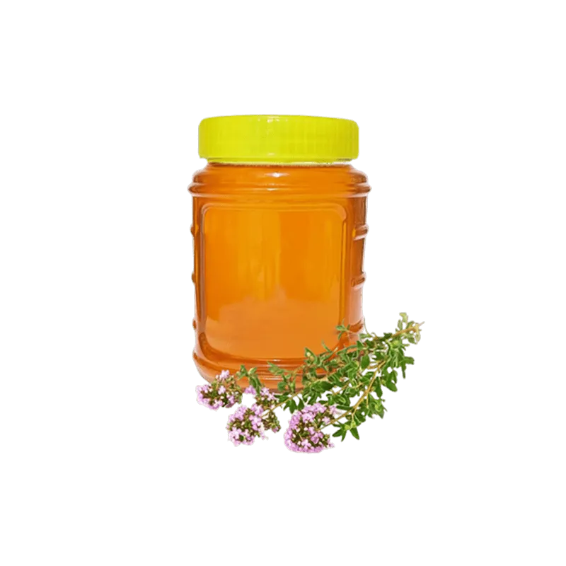 عکس یک شیشه عسل اویشن به همراه سه شاخه گل آویشن در کنار آن