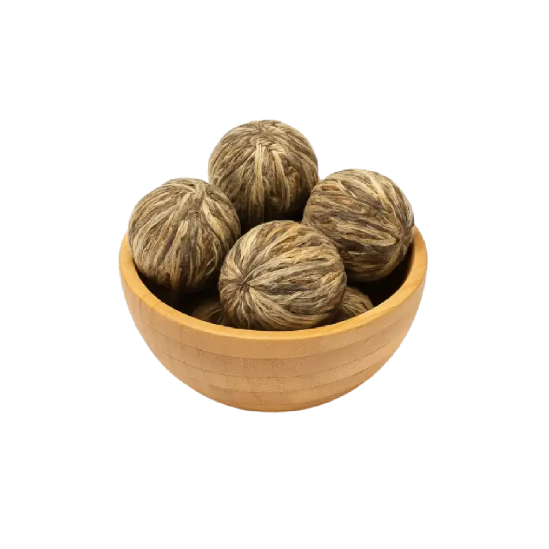 عکس تعدادی چای بلومینگ بسته و خشک در کاسه چوبی